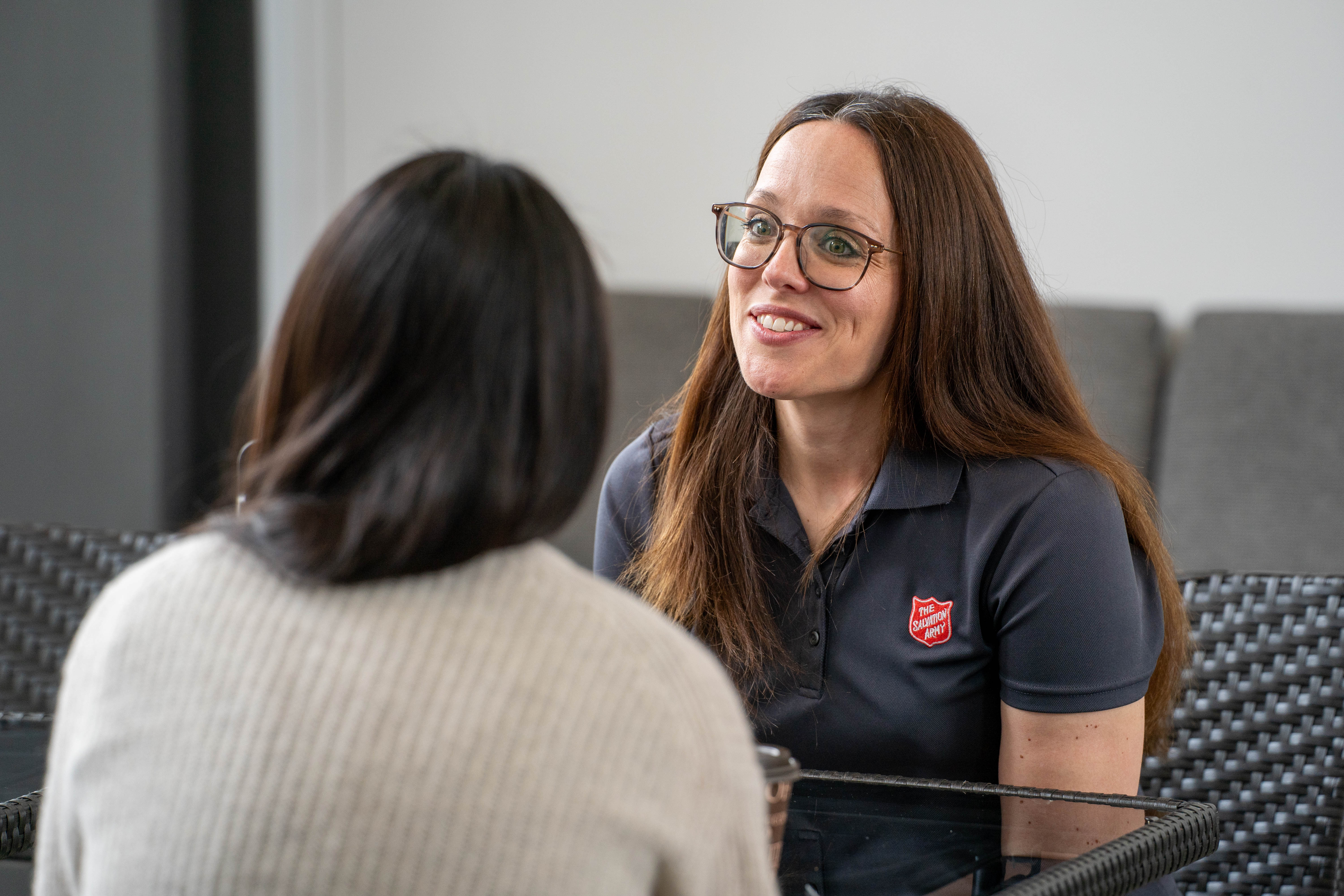 Salvation Army staff member speaking with a visitor during an in-person donation.